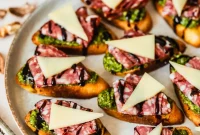 Pesto Crostini with Parmesan and Soppressata