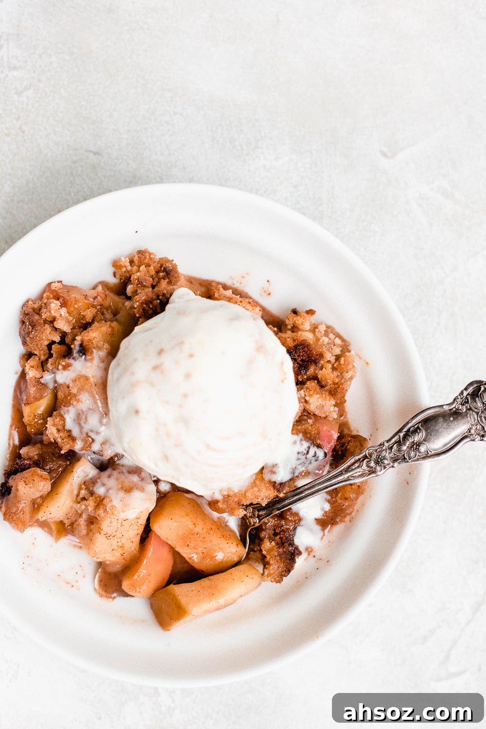 bowl filled with apples and crumble topped with ice cream