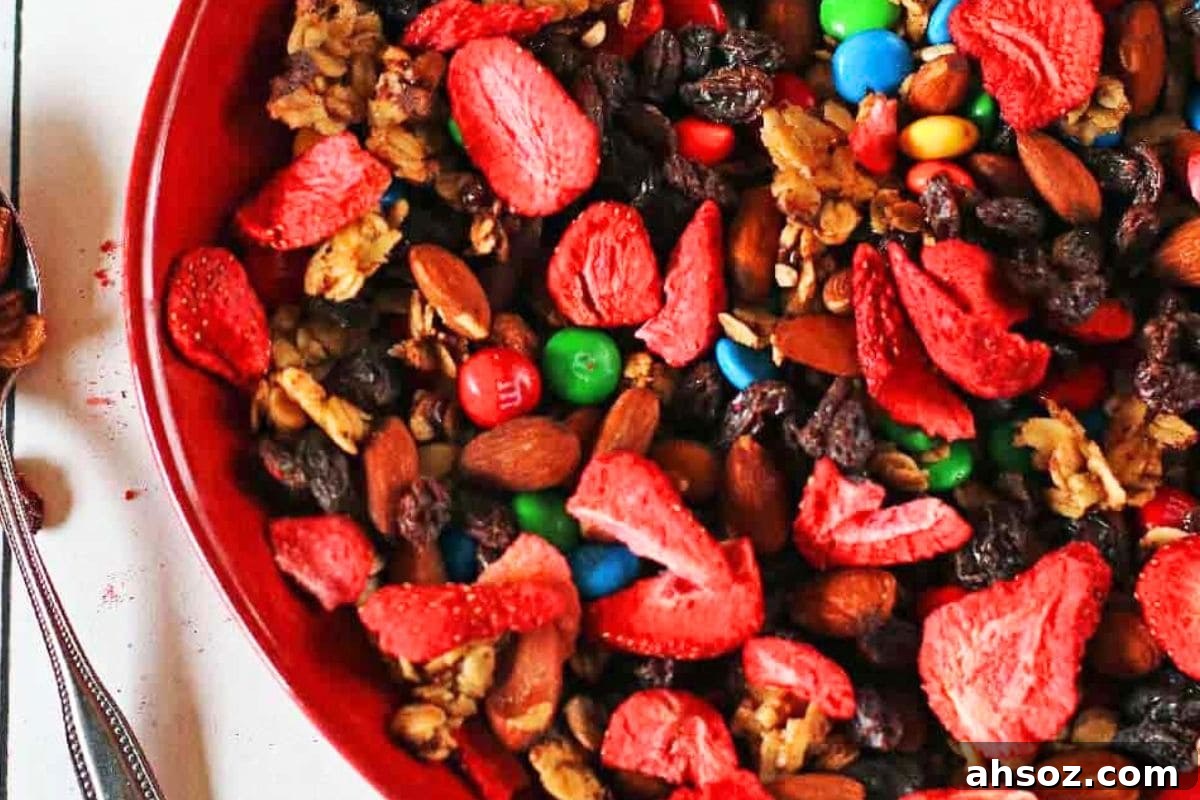 Homemade trail mix with granola raisins dried strawberries chocolate and nuts