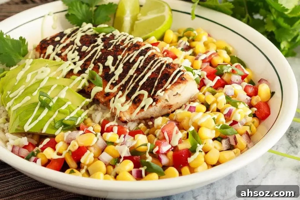 Fresh blackened fish taco bowl with corn salsa, rice, and avocado