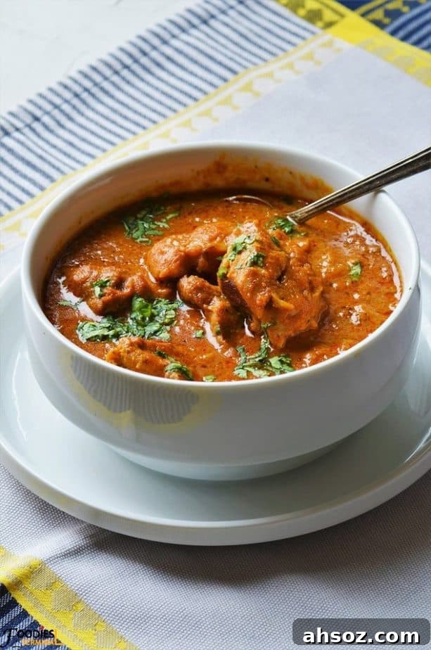 Boneless chicken gravy garnished with cilantro in a bowl