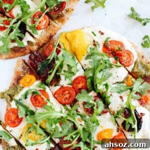 Garlicky pesto flatbread pizza with tomatoes and arugula