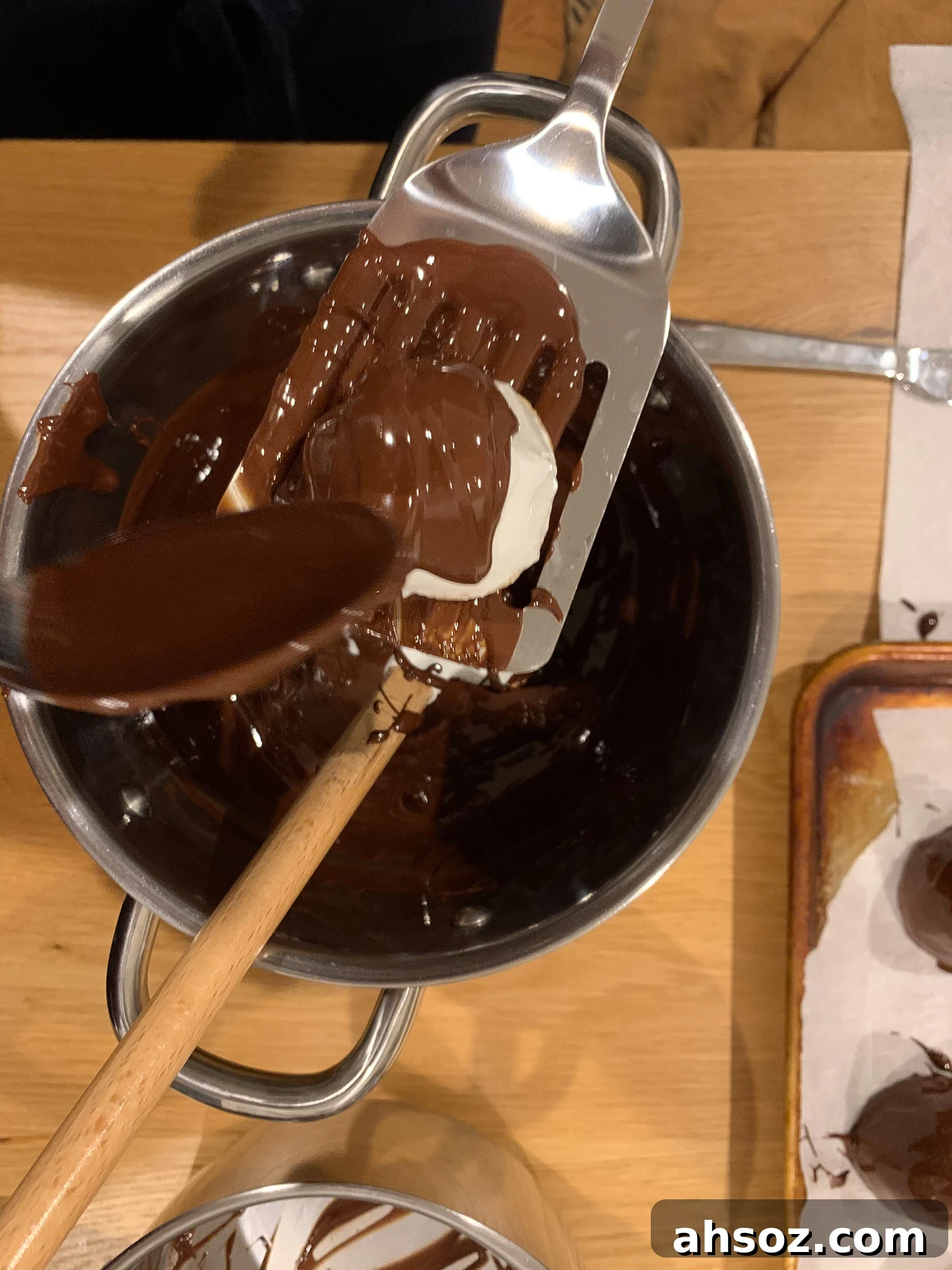 Covering the meringue in tempered chocolate.
