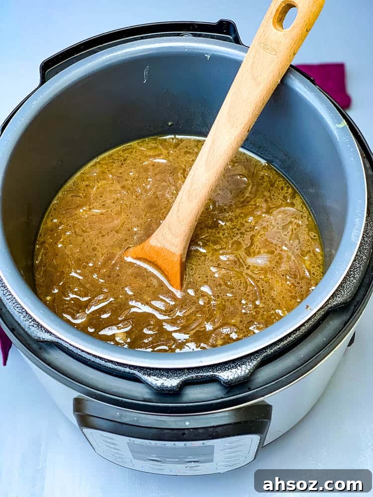 Instant Pot French Onion Soup with a wooden spoon