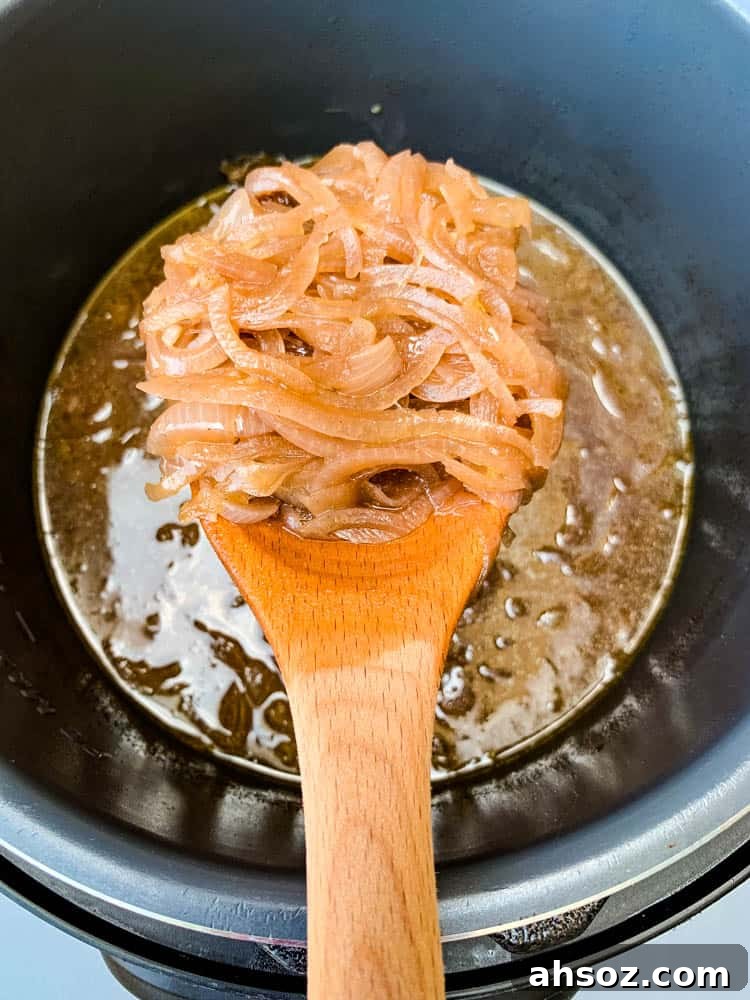 Instant Pot French Onion Soup with a wooden spoon