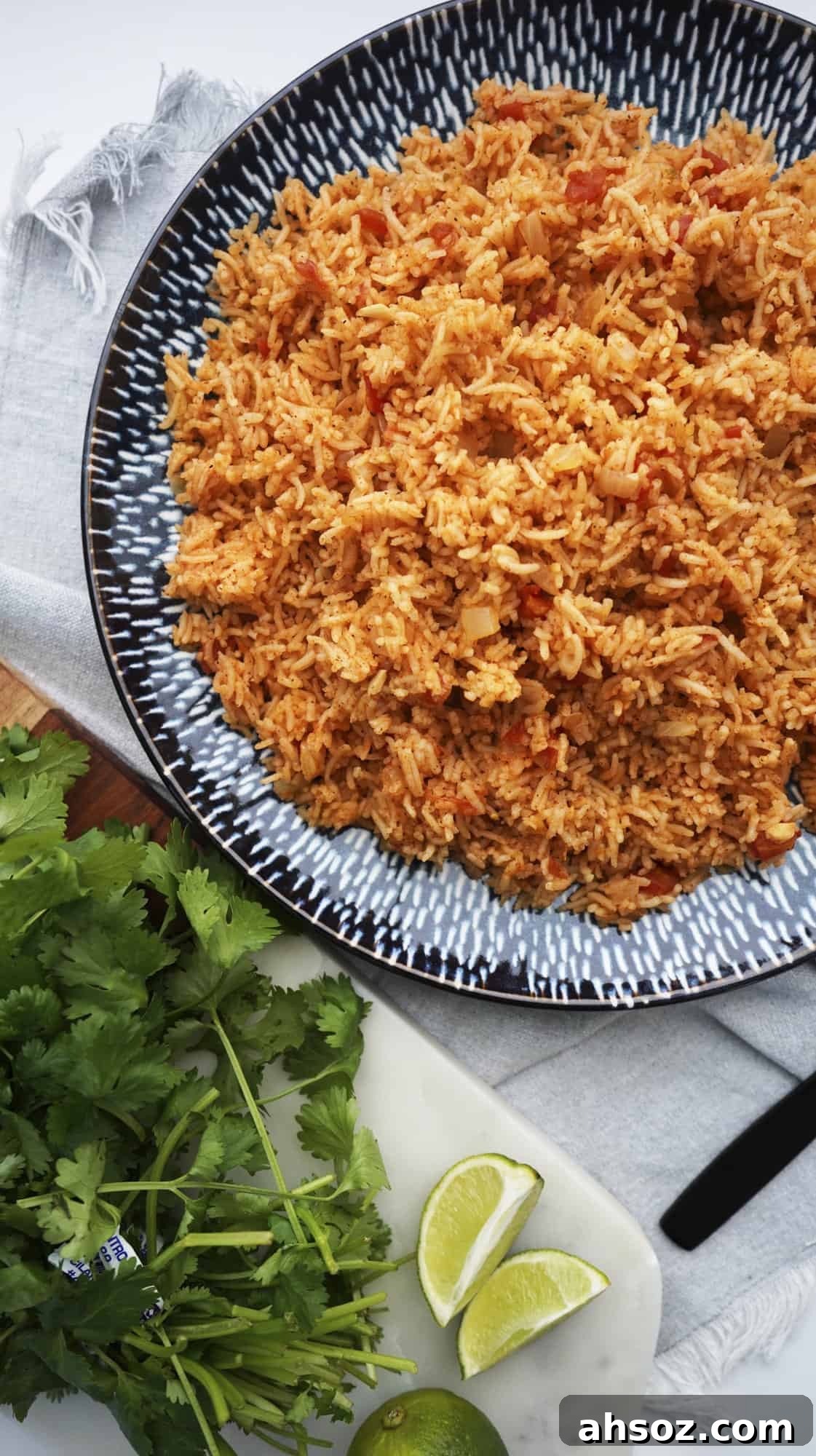 overhead of spanish rice with fresh lime and cilantro