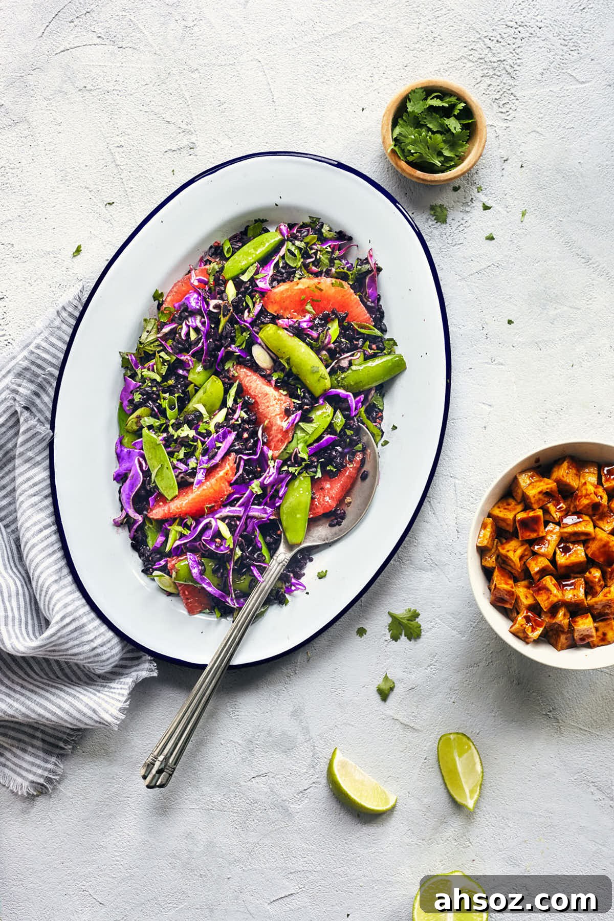 Serving spoon digging into Asian black rice salad