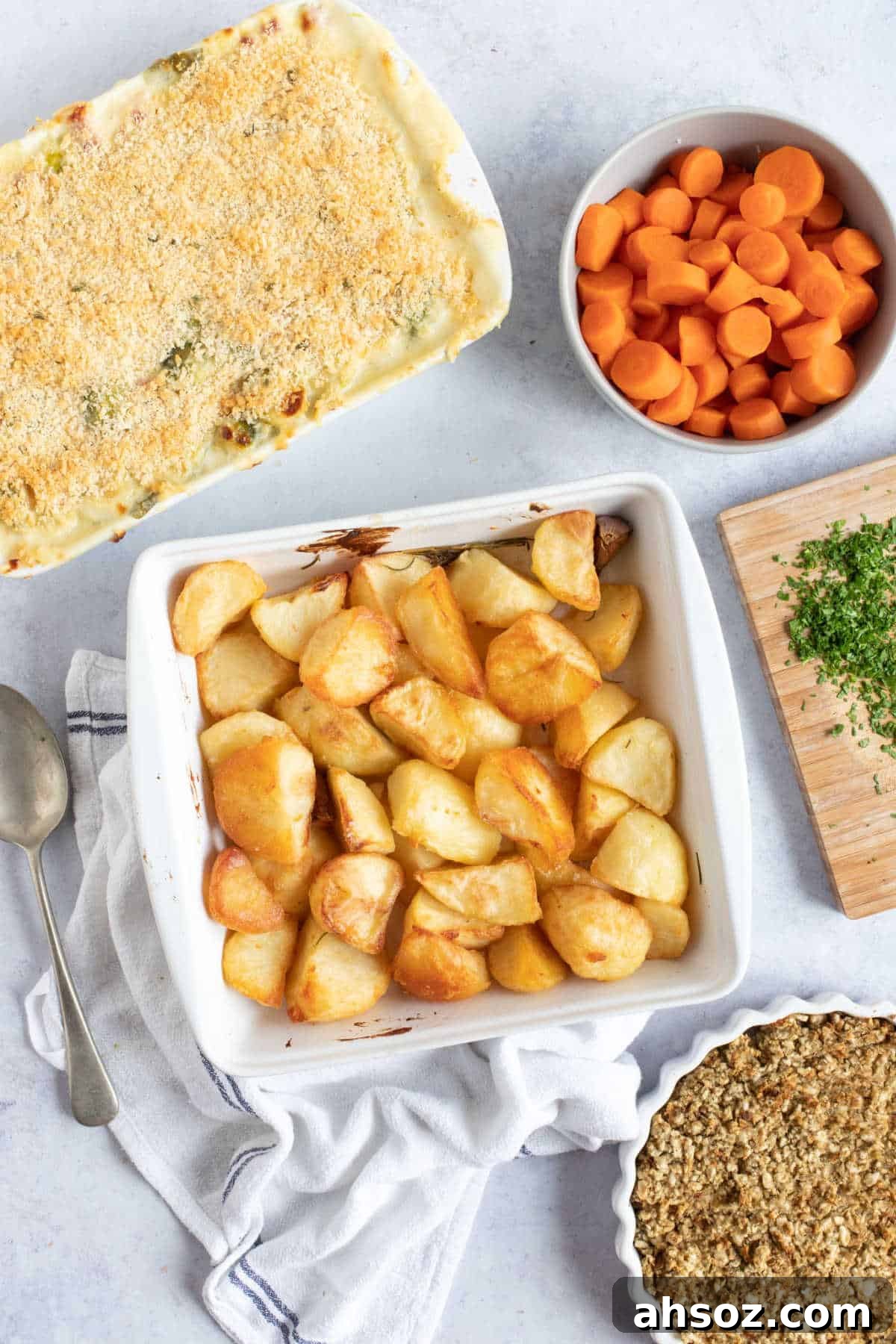 Potatoes in a white dish with carrots and stuffing.