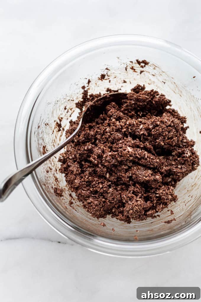 chocolate coconut macaroon dough in a clear mixing bowl