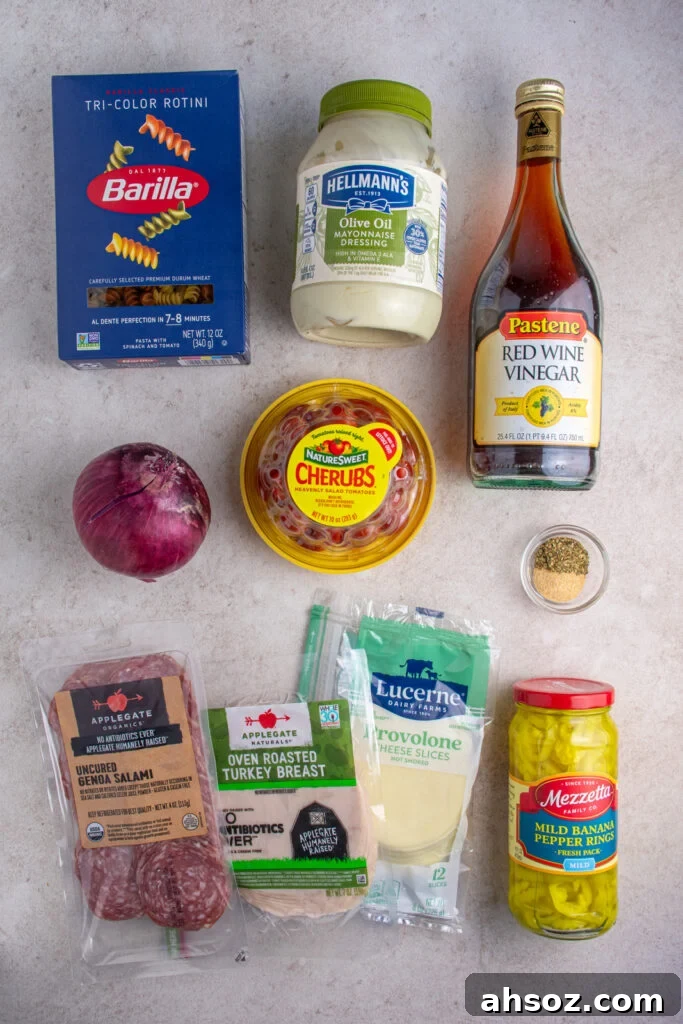 Ingredients needed for making grinder pasta salad laid out on a tabletop.