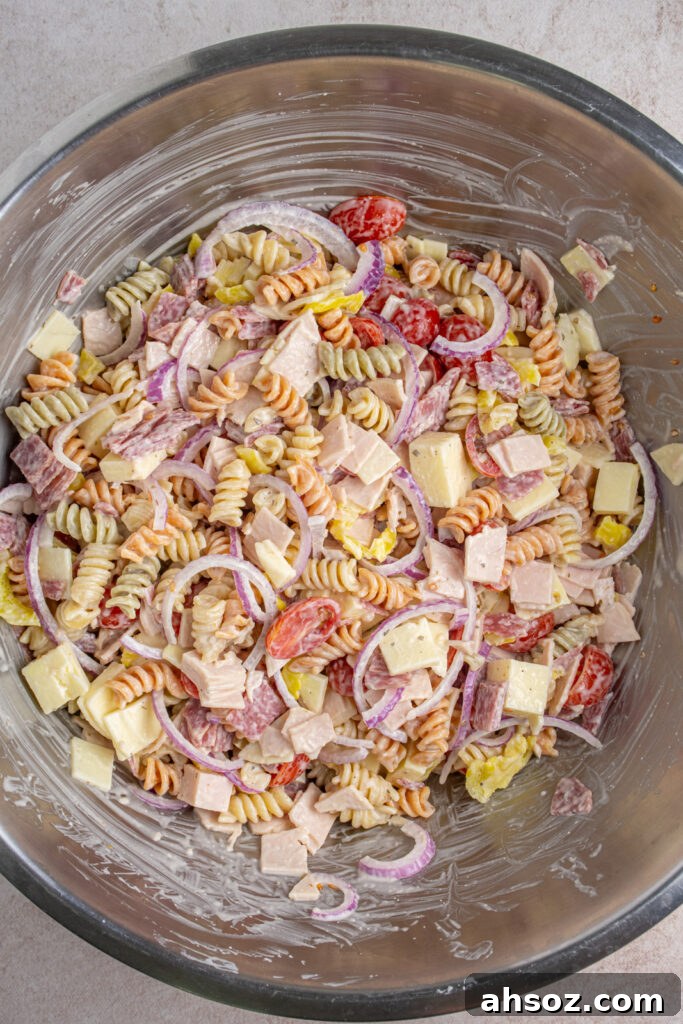 A large bowl filled with freshly mixed grinder pasta salad.