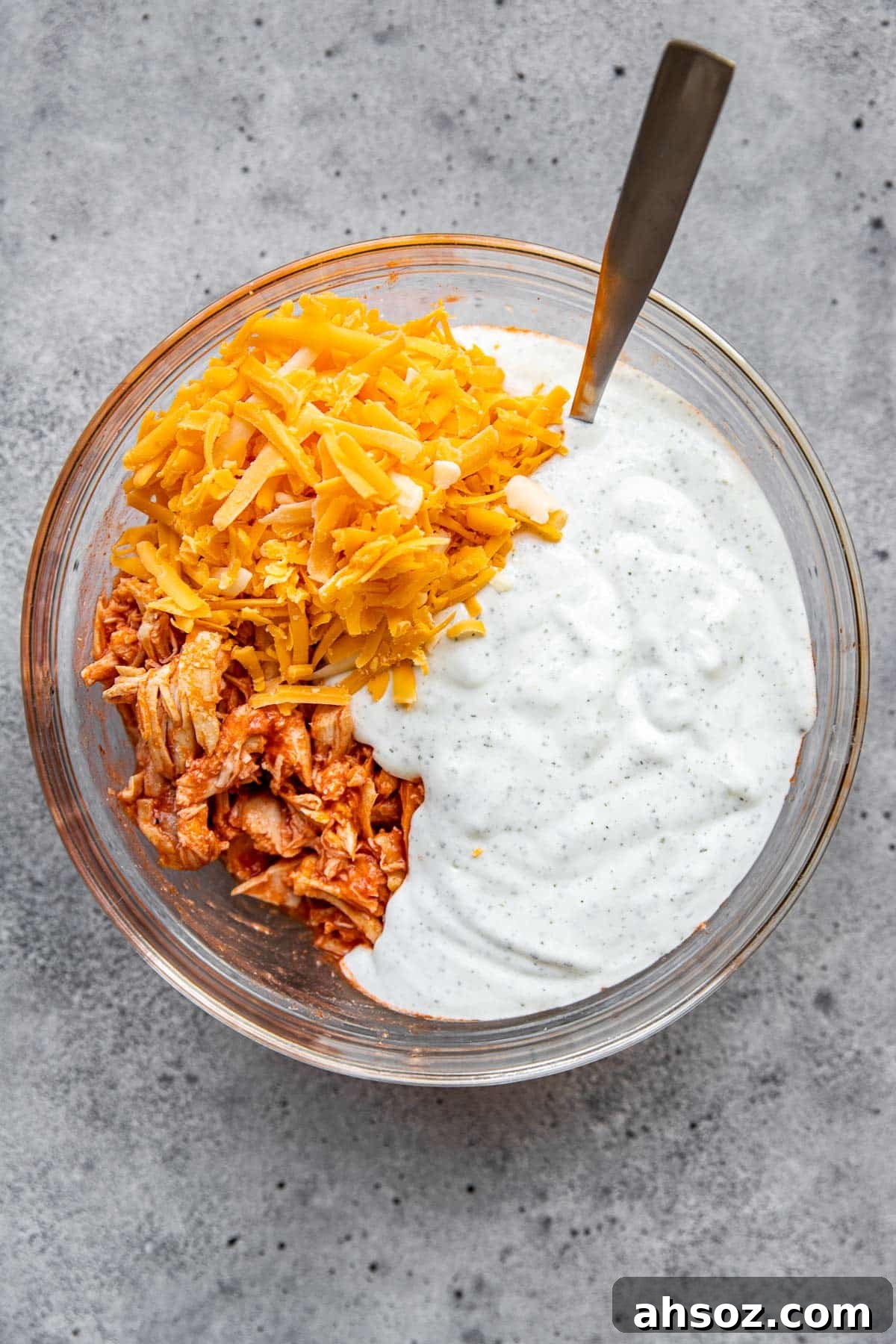 chicken, cheese and sauce in a glass bowl. 