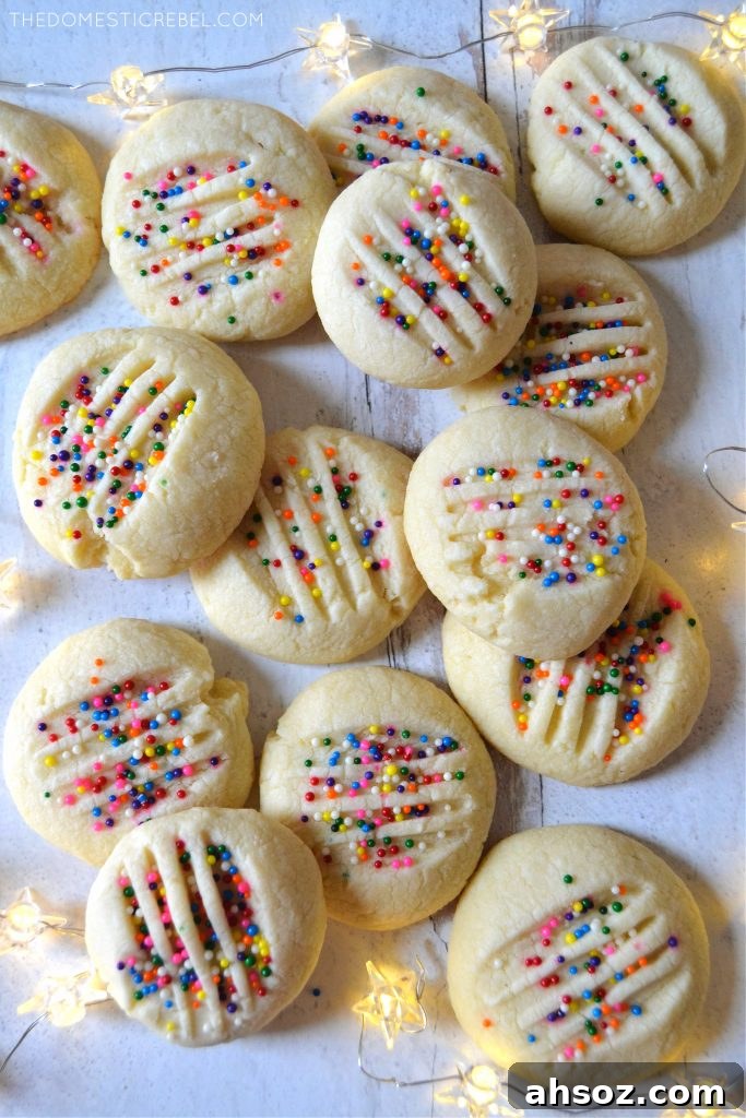 Buttery Whipped Shortbread Cookies That Melt in Your Mouth 3 Arrangement of whipped shortbread cookies on white wood with twinkle lights