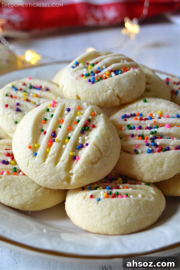 Buttery Whipped Shortbread Cookies That Melt in Your Mouth 5 Closeup stack of whipped shortbread cookies on a white plate