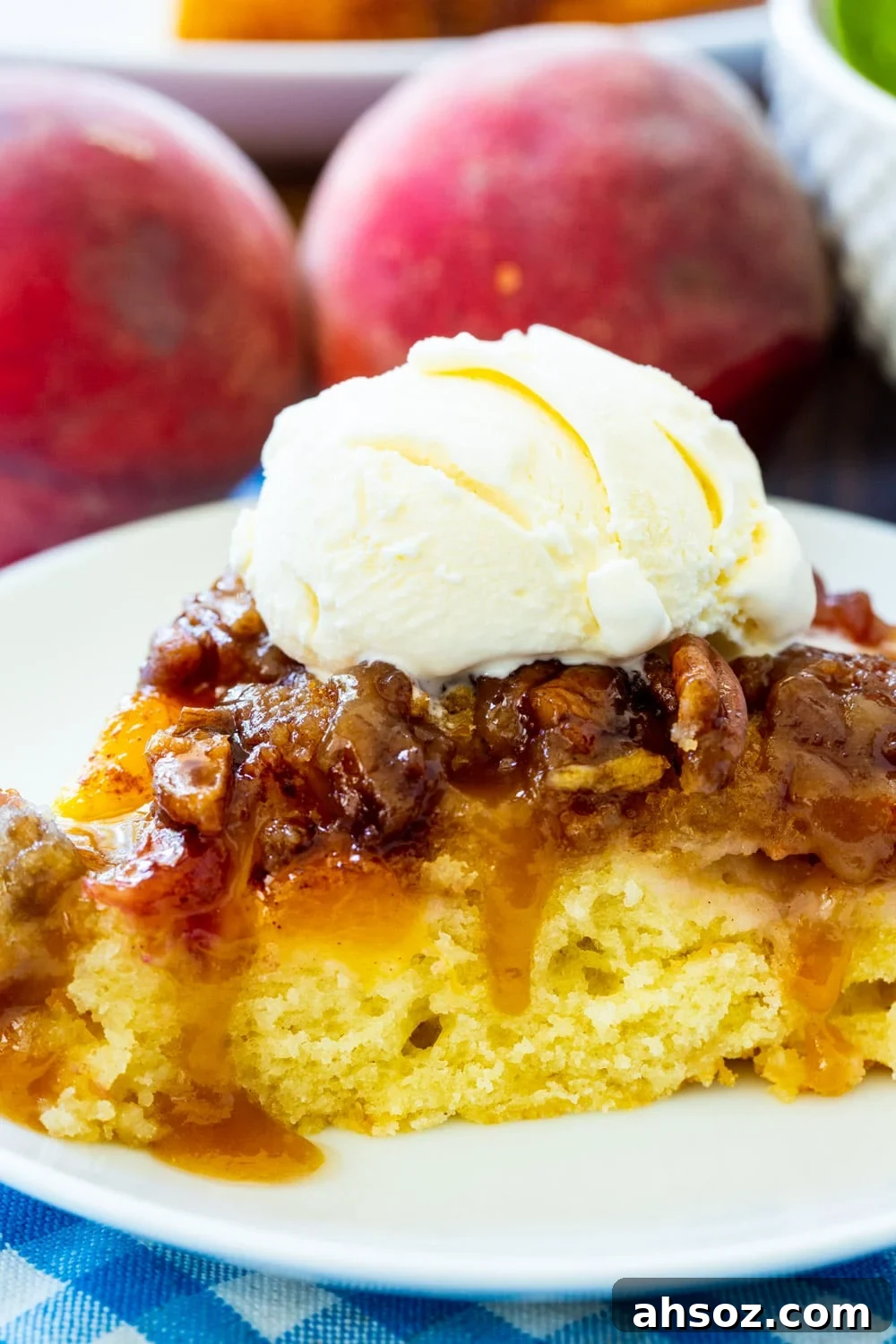 Close-up of slice of Peach Praline Upside Down Cake topped with vanilla ice cream.