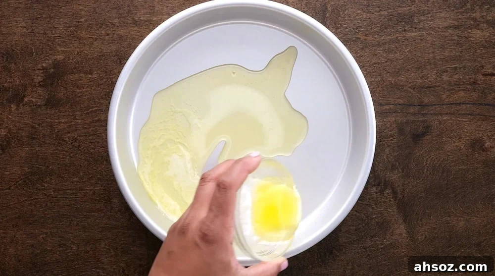 Melted butter poured into cake pan.
