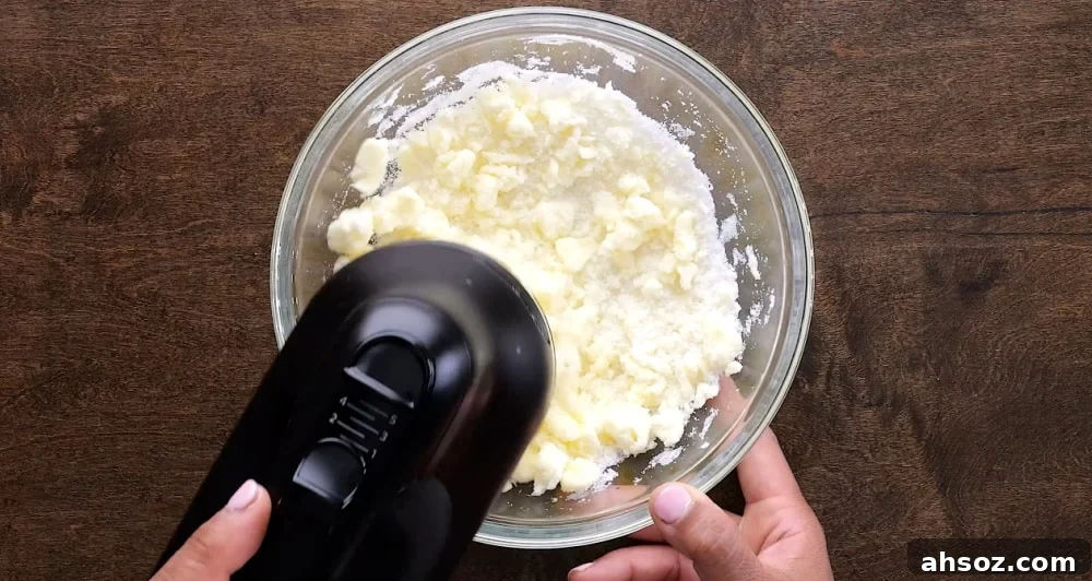 Beating butter and sugar with electric mixer.