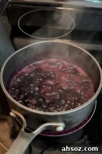 simmering homemade blueberry jam on the stove