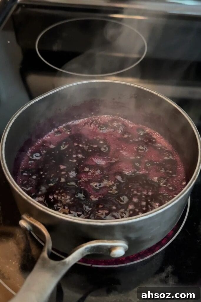 simmering homemade blueberry jam on the stove