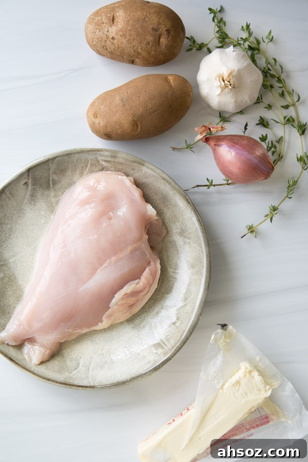 marble counter with chicken breast potatoes garlic shallot thyme and butter