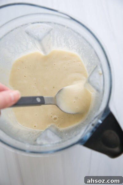 blender full of gluten-free cream of chicken soup with spoon