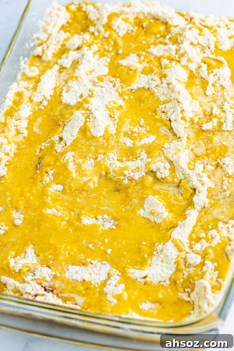cinnamon spiced cake mix spread over caramel and pie filling with melted butter poured all over the top