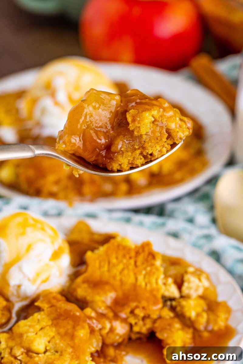 close up of a spoonful of caramel apple dump cake over the plate
