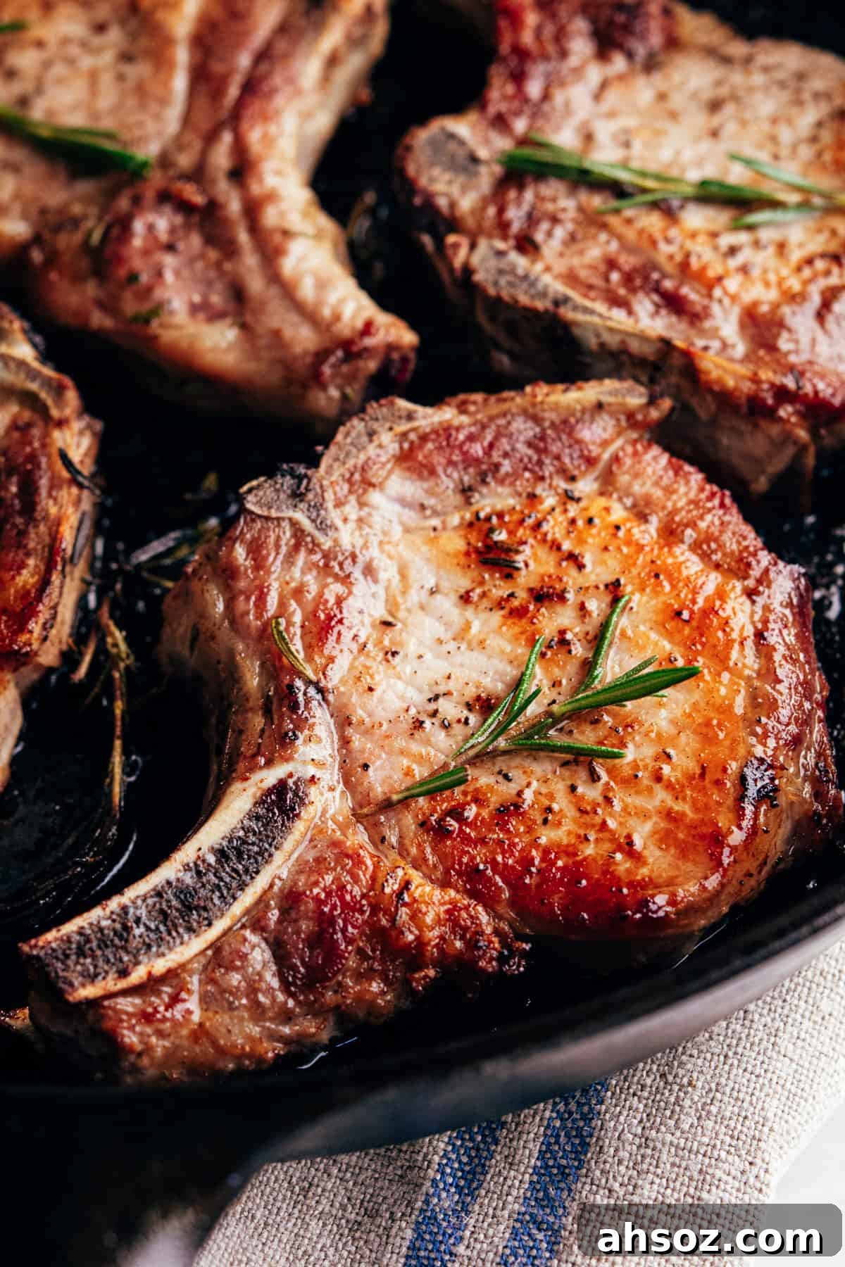 seared pork chops in a cast iron pan.