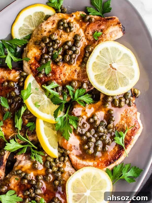 Pork Piccata served on a gray oval platter.