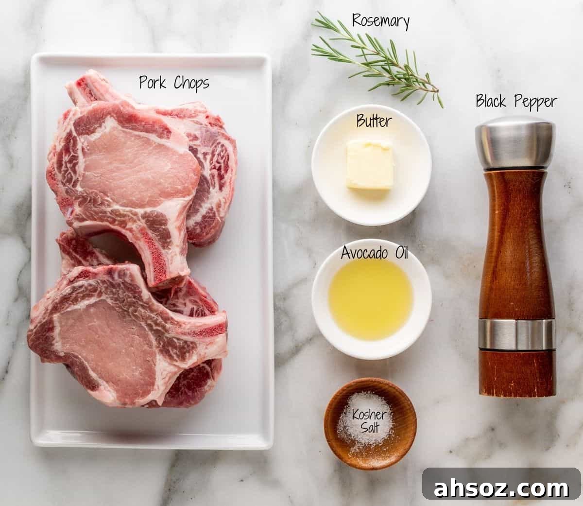 Cast Iron Pork Chops Ingredients on a white marble board.