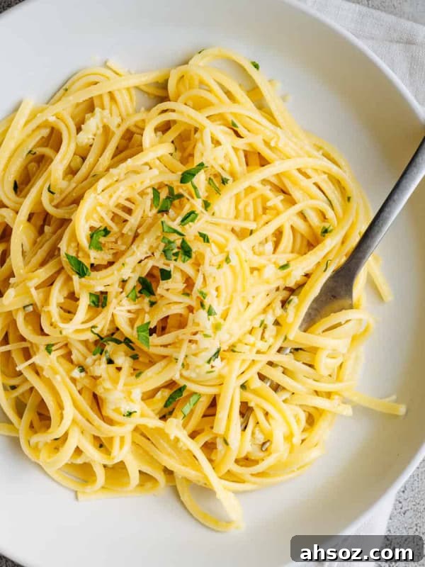 Garlic Butter Noodles served in a white bowl and photographed from above.