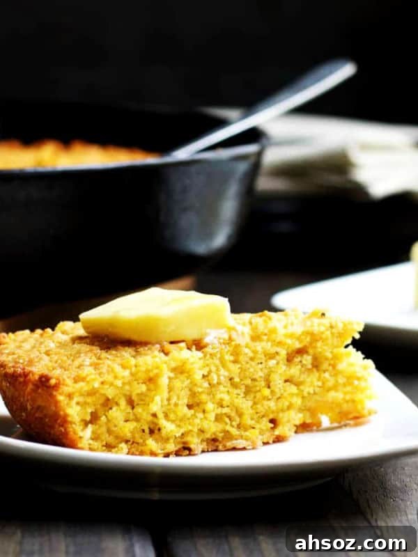 Skillet-Cornbread-served-with-butter on a white plate