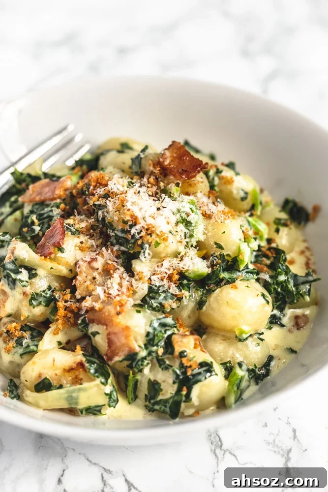 A side view of bowl of creamy kale gnocchi.