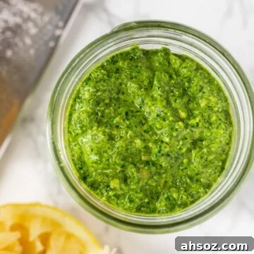A close up view of kale pesto in a mason jar.