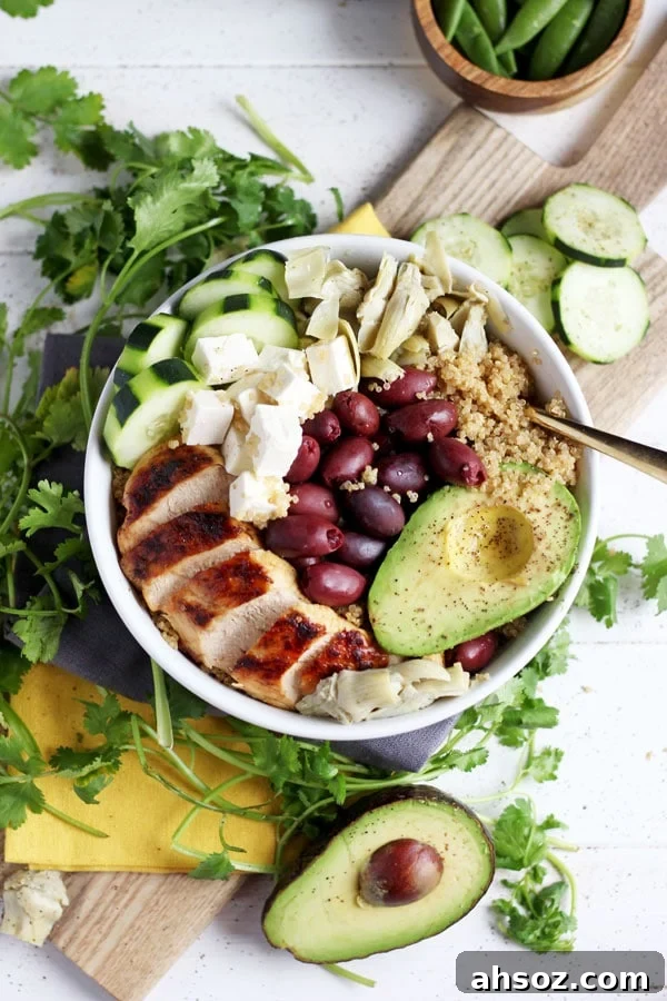 All the toppings added to a chicken quinoa bowl.