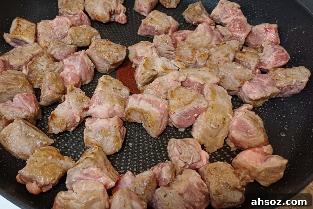 browning pork in a frying pan