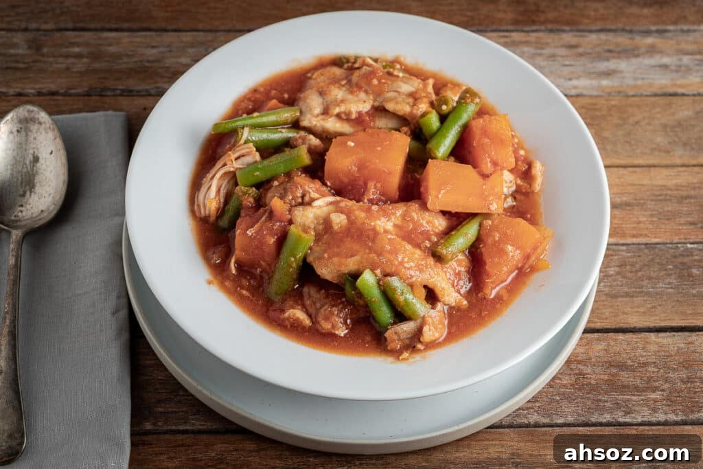 slow cooker chicken and sweet potato stew on a wooden background