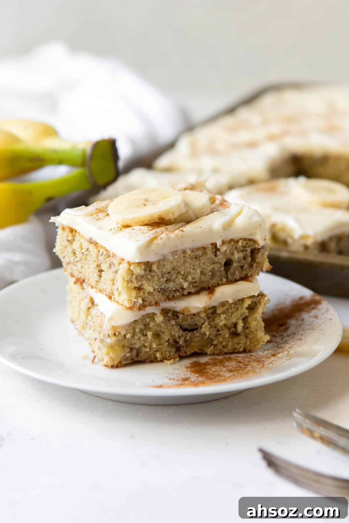 Two banana bars stacked on top of each other on a white plate