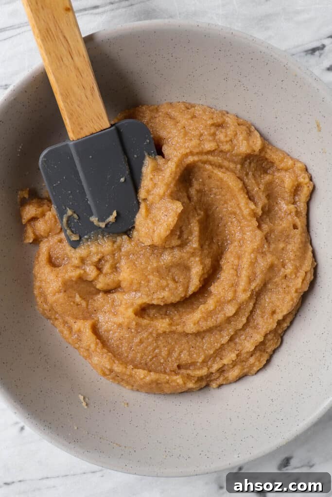 Apple cinnamon donut hole batter in a mixing bowl
