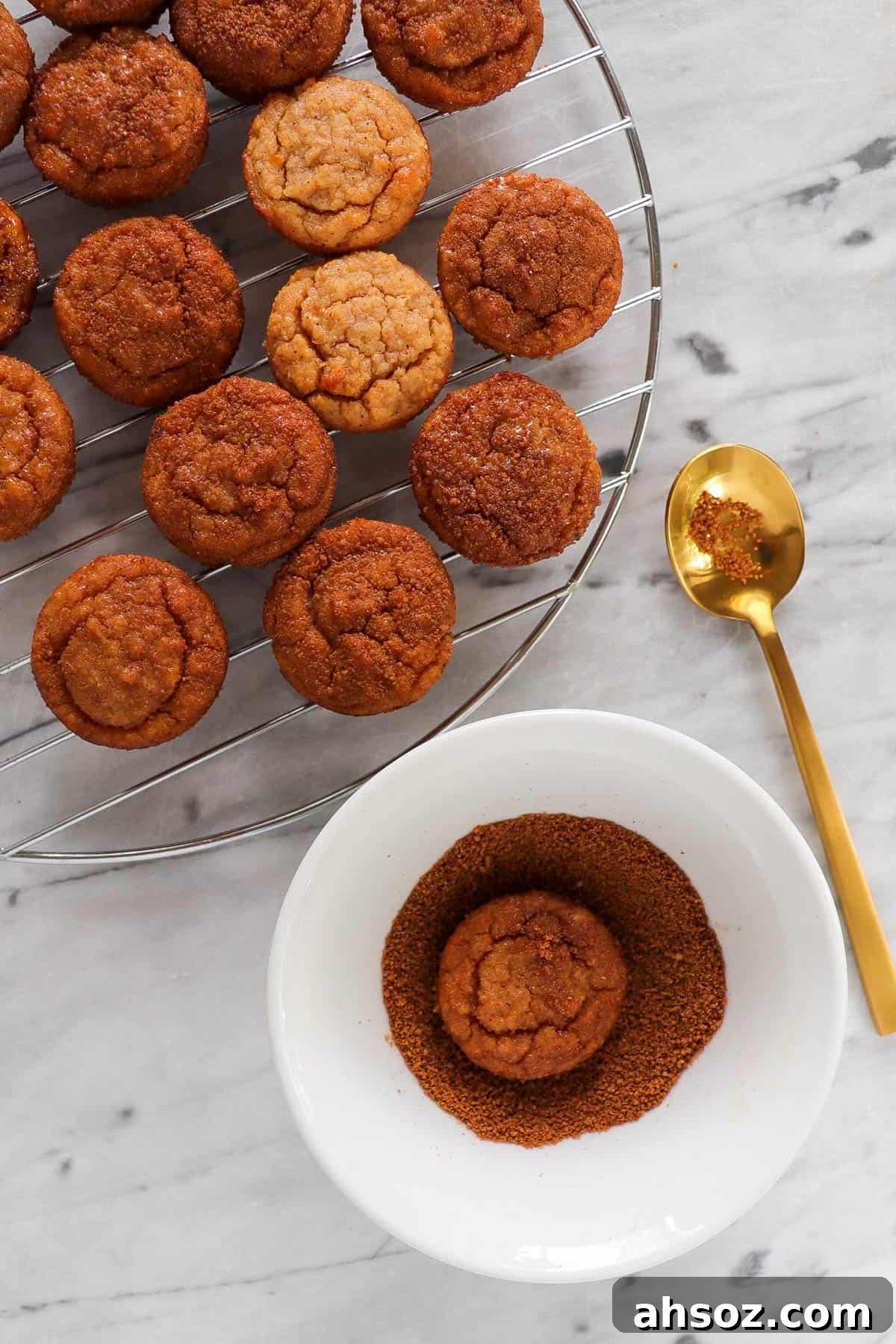 Donut holes being dipped in cinnamon sugar topping