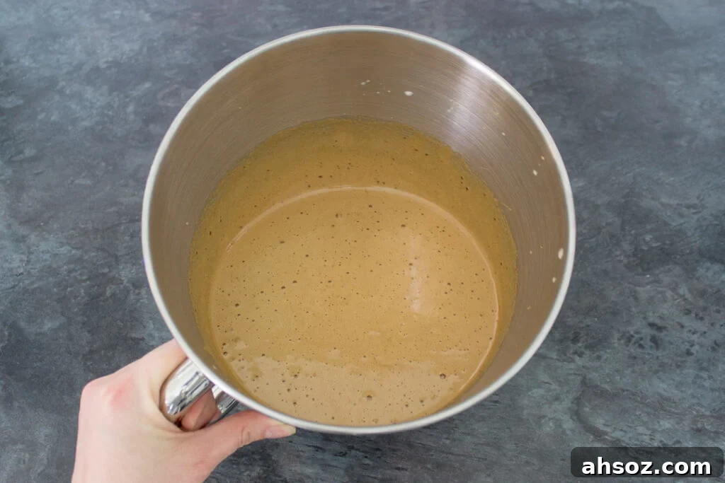 Whisked eggs and dark muscovado sugar in a mixing bowl.