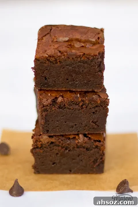 A stack of 3 fudgy chocolate brownies.