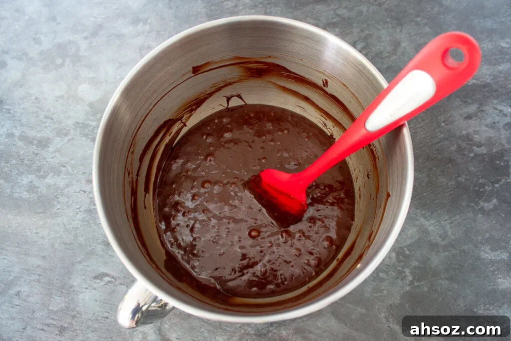 Brownie batter in a mixing bowl with a spatula.