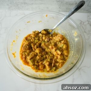 Cornbread dressing filling in a glass bowl.