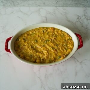Cornbread dressing in a baking dish before baking.