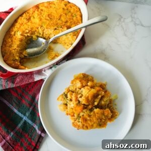 Golden brown cornbread dressing in a small baking dish with a soft center and crisp, buttery edges.