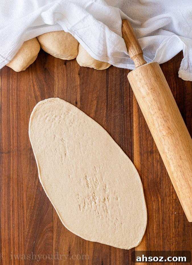 Rolled out naan bread on cutting board