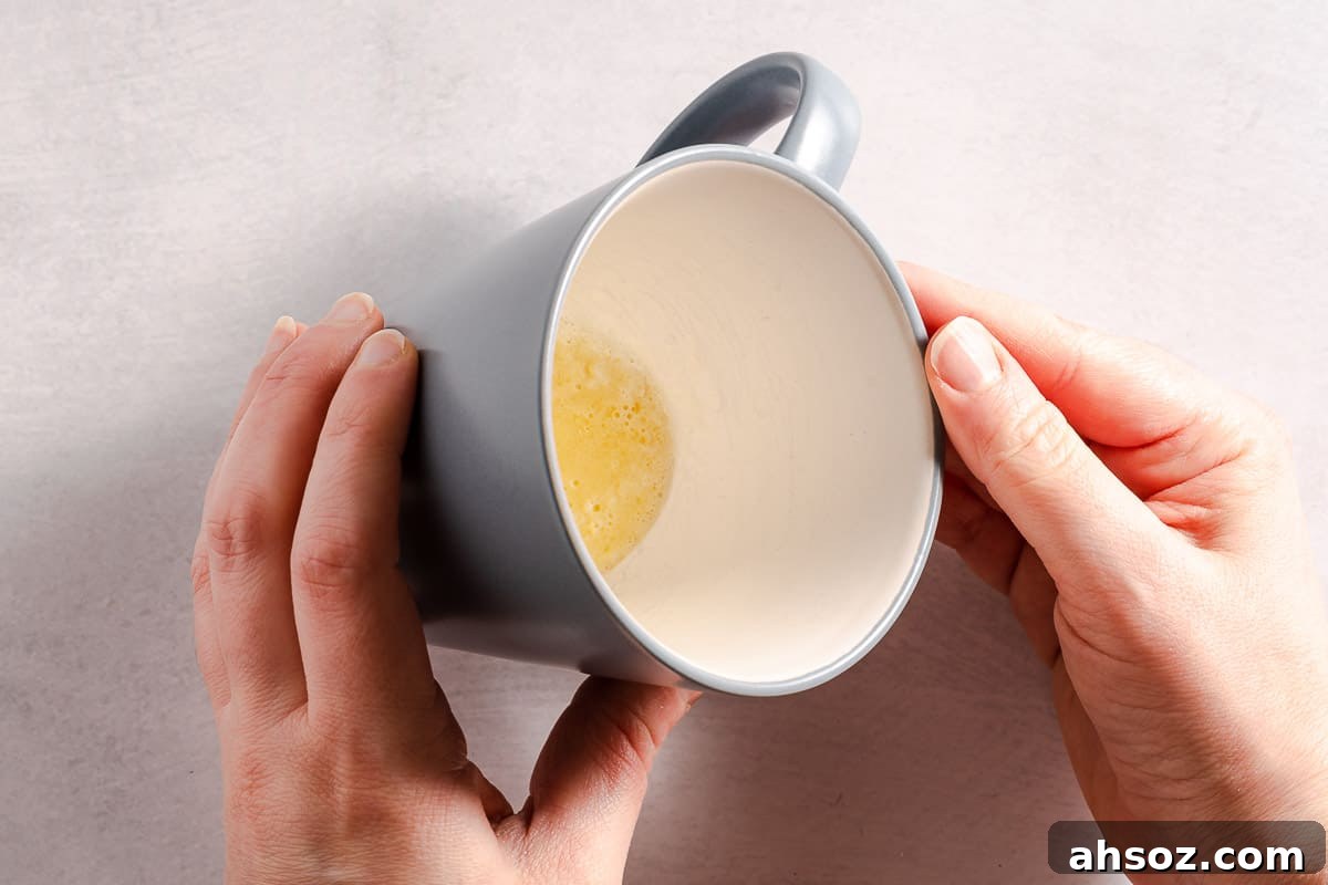 butter being swirled around inside a blue mug