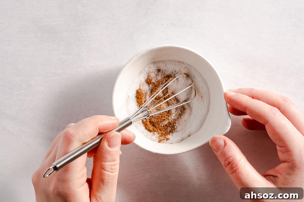 cinnamon and sugar being mixed together in small bowl