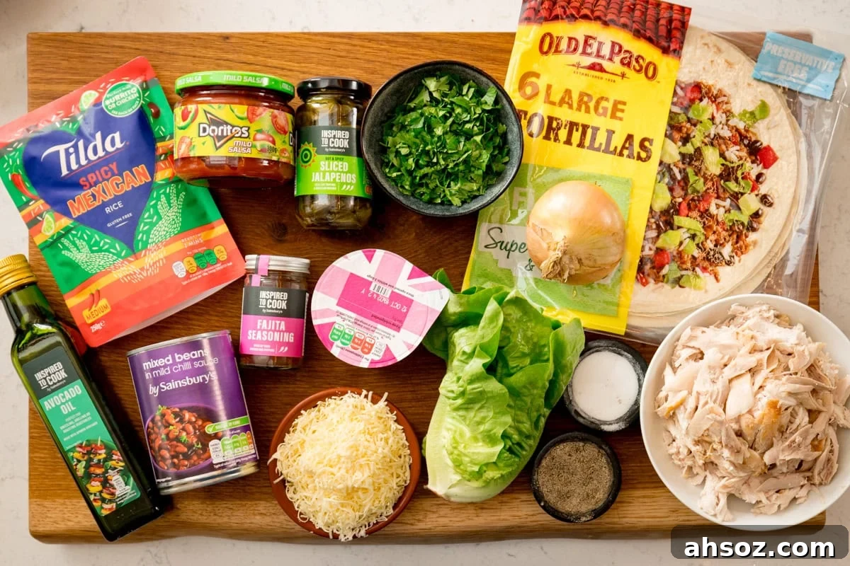 Ingredients for quick chicken burritos on a wooden board, including tortillas, tinned beans, grated cheese, rotisserie chicken, microwave rice, lettuce, jarred jalapenos, an onion, fajita spice, seasoning, sour cream and salsa.